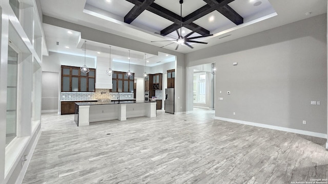 kitchen featuring coffered ceiling, ceiling fan, and open floor plan