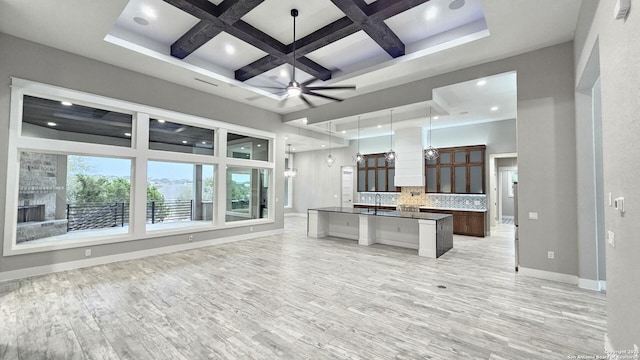 kitchen with decorative backsplash, open floor plan, ceiling fan, coffered ceiling, and baseboards