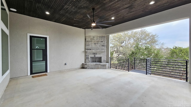 view of patio with ceiling fan and a balcony