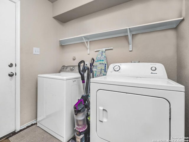 clothes washing area with washer and dryer and laundry area