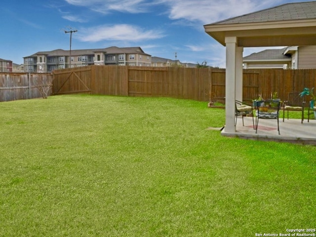 view of yard with a patio area and a fenced backyard