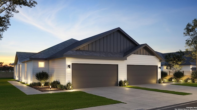 view of front facade featuring roof with shingles, board and batten siding, a front yard, a garage, and driveway