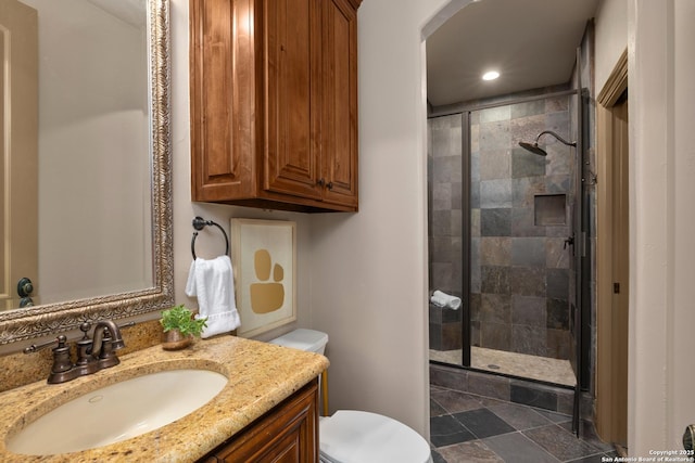 bathroom with recessed lighting, toilet, a stall shower, stone finish floor, and vanity