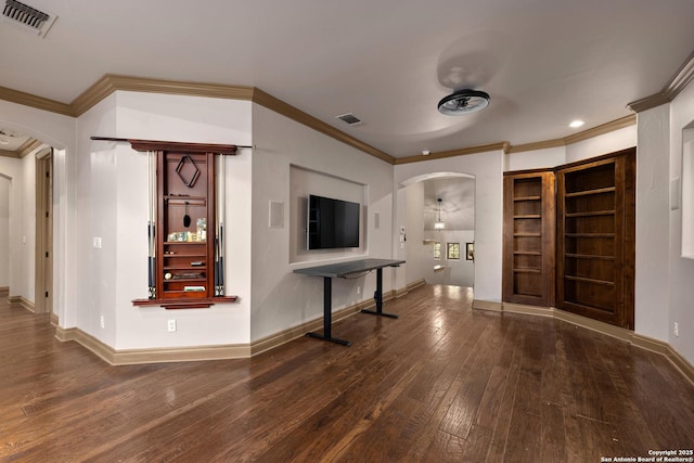 foyer entrance with visible vents, arched walkways, wood-type flooring, and baseboards