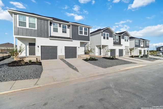 view of front of home featuring a residential view, concrete driveway, and an attached garage