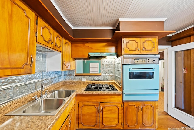 kitchen with white oven, brown cabinets, a warming drawer, gas stovetop, and a sink