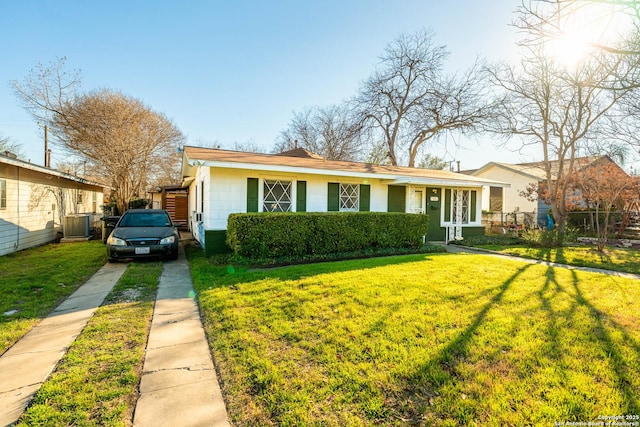 view of front of house with driveway, a front lawn, and central air condition unit