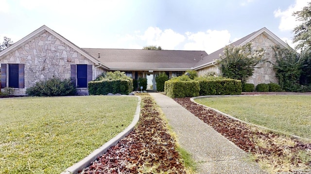 view of front of property featuring stone siding and a front yard