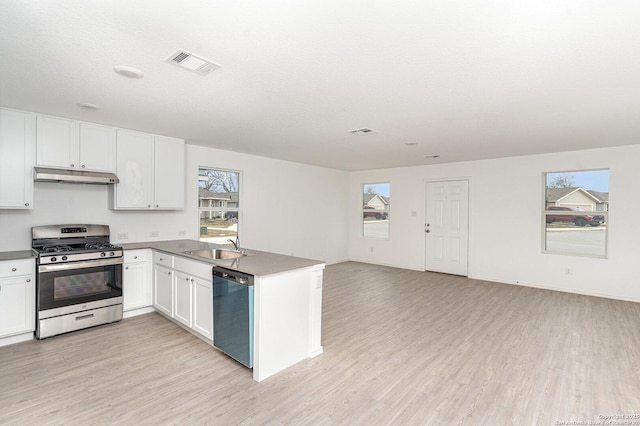 kitchen with stainless steel range with gas cooktop, visible vents, open floor plan, dishwasher, and under cabinet range hood