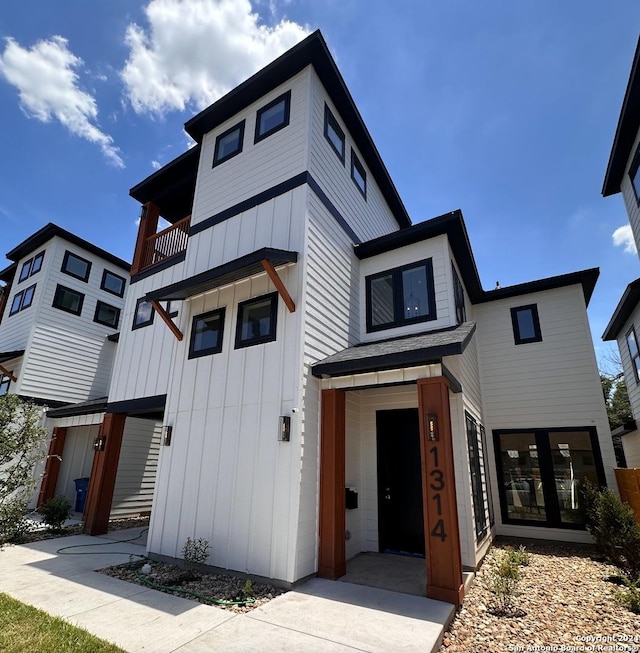 contemporary house with board and batten siding and a balcony