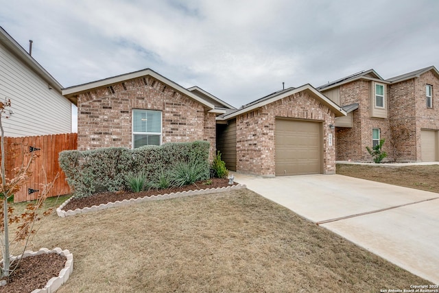 view of front of home featuring driveway, brick siding, an attached garage, and fence