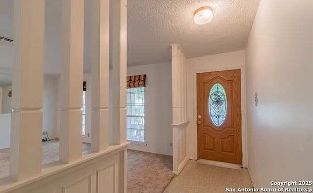 foyer entrance featuring a textured ceiling