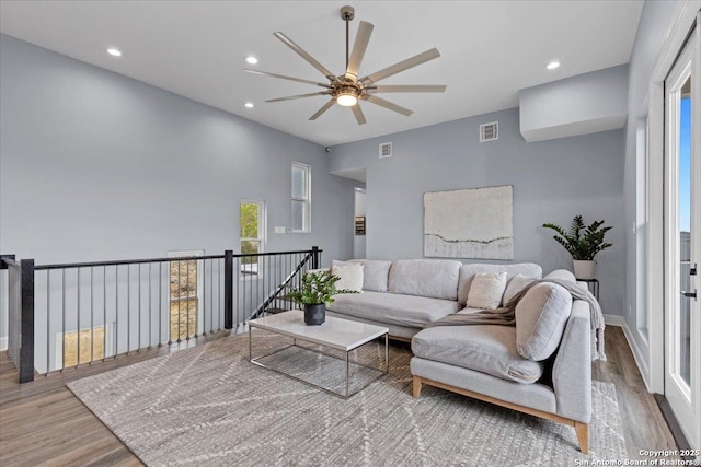 living area featuring wood finished floors, visible vents, and recessed lighting