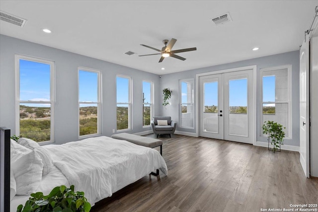 bedroom featuring access to outside, visible vents, dark wood-type flooring, and french doors