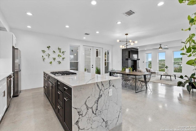 kitchen featuring recessed lighting, stainless steel appliances, visible vents, white cabinetry, and french doors