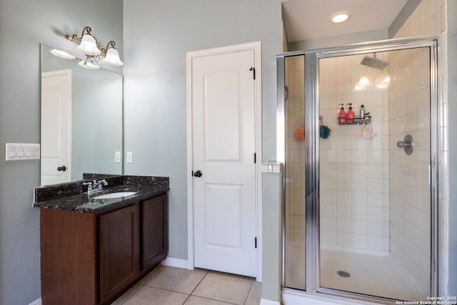 full bathroom with tile patterned flooring, vanity, and a shower stall