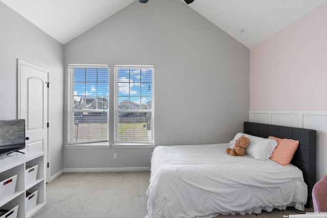 bedroom featuring carpet and high vaulted ceiling