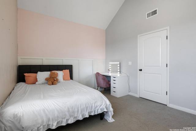 bedroom featuring carpet, visible vents, and lofted ceiling