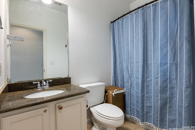 bathroom with visible vents, toilet, vanity, a shower with curtain, and tile patterned floors