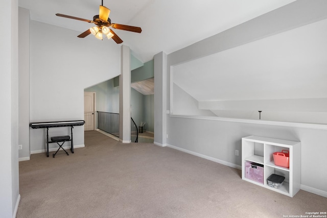 interior space featuring lofted ceiling, carpet, and baseboards