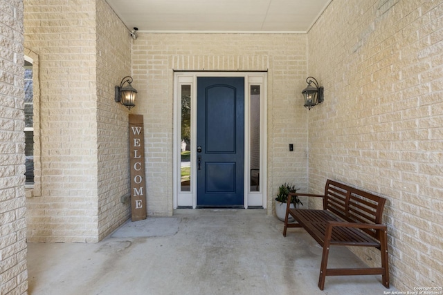 property entrance featuring brick siding