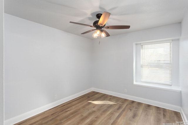 unfurnished room with ceiling fan, baseboards, and wood finished floors