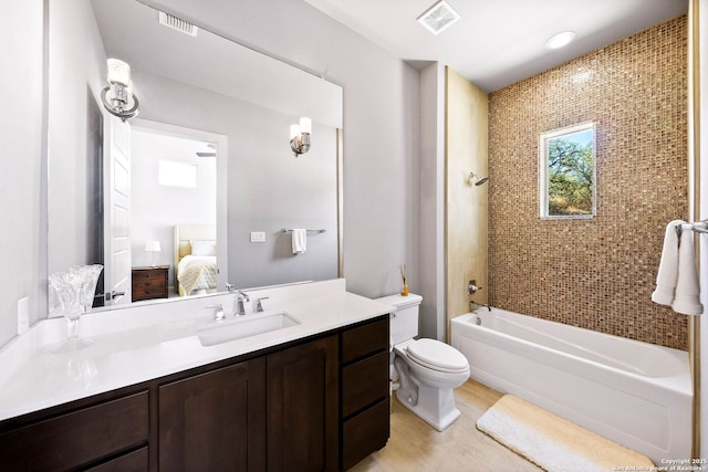 ensuite bathroom featuring visible vents, connected bathroom, vanity, and toilet