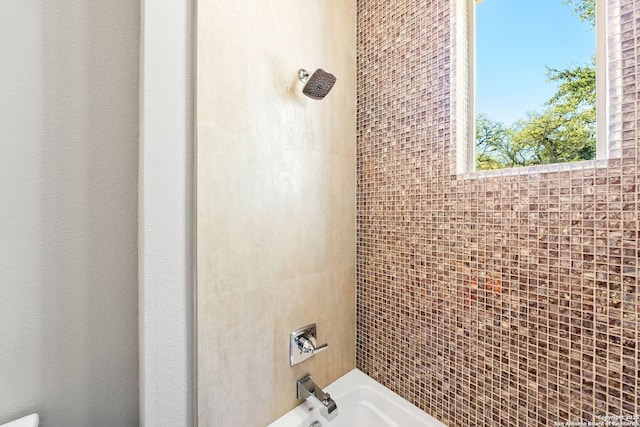 bathroom with bathing tub / shower combination