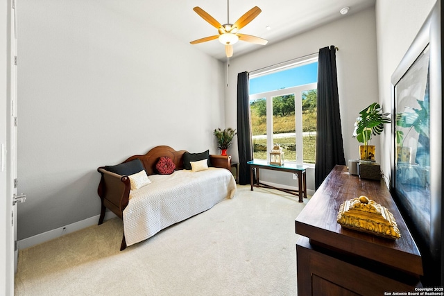 carpeted bedroom featuring ceiling fan and baseboards