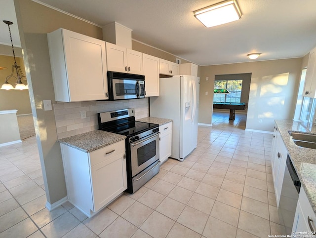 kitchen featuring tasteful backsplash, appliances with stainless steel finishes, light tile patterned flooring, white cabinetry, and a sink