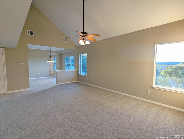 spare room featuring a healthy amount of sunlight, light colored carpet, and visible vents