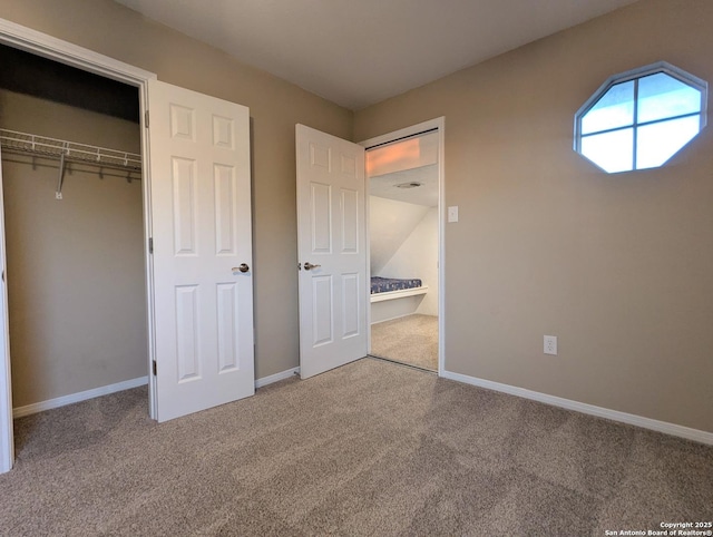 unfurnished bedroom featuring a closet, carpet flooring, and baseboards