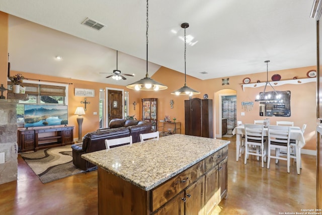 kitchen featuring visible vents, a ceiling fan, finished concrete flooring, arched walkways, and lofted ceiling