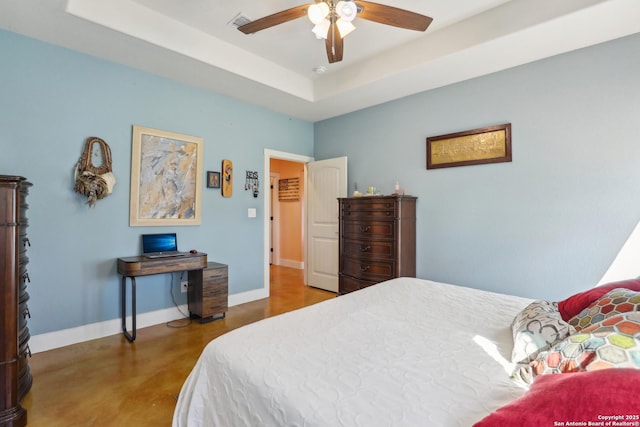 bedroom with a ceiling fan, visible vents, baseboards, finished concrete floors, and a raised ceiling