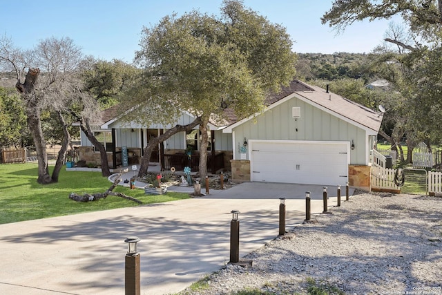 view of front of property with concrete driveway, an attached garage, board and batten siding, and a front lawn