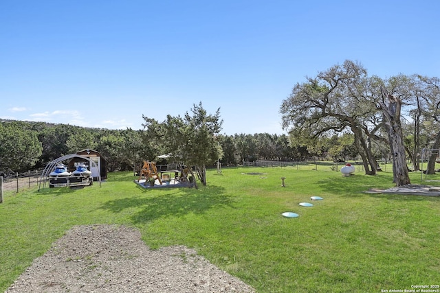 view of yard featuring a carport and fence