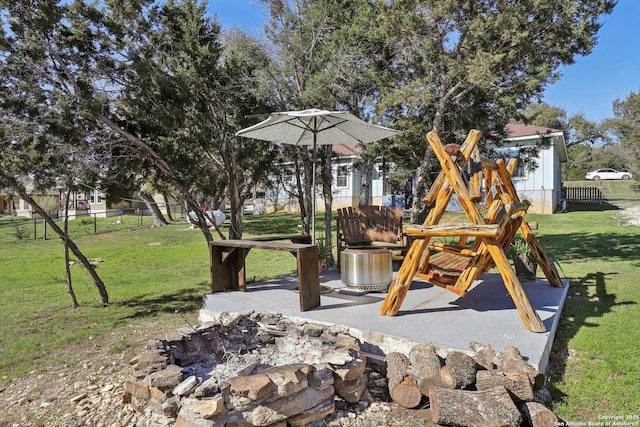 view of jungle gym featuring a patio, a lawn, and fence