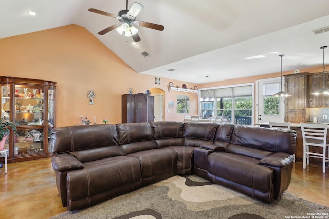 living area with visible vents, finished concrete floors, high vaulted ceiling, and ceiling fan