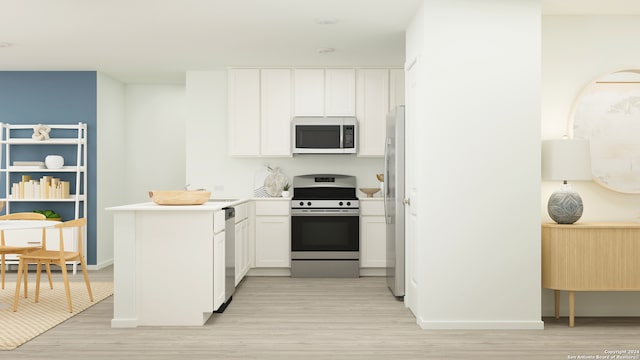 kitchen featuring stainless steel appliances, a peninsula, light wood-style flooring, and white cabinets