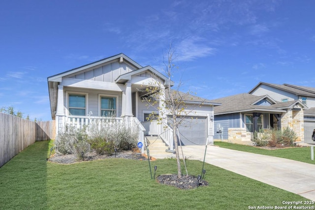 craftsman-style home with a porch, an attached garage, driveway, a front lawn, and board and batten siding