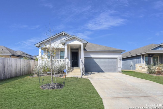 view of front of property with a garage, covered porch, fence, driveway, and a front lawn