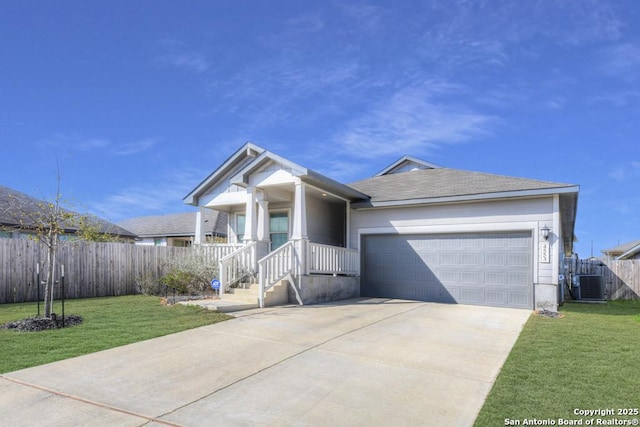 view of front of home with concrete driveway, an attached garage, fence, central air condition unit, and a front yard