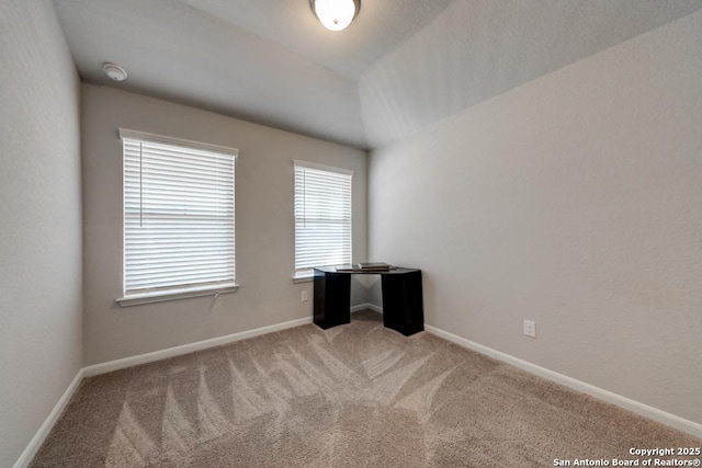 empty room featuring baseboards and carpet flooring