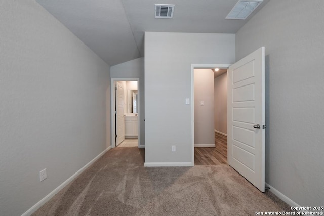 unfurnished bedroom featuring carpet floors, visible vents, and baseboards