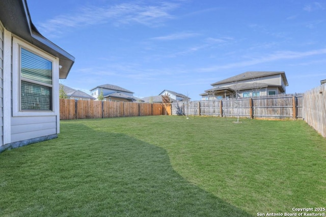 view of yard with a fenced backyard