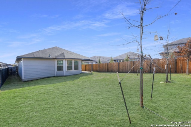 view of yard with a fenced backyard