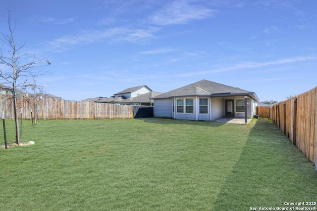 view of yard with a fenced backyard