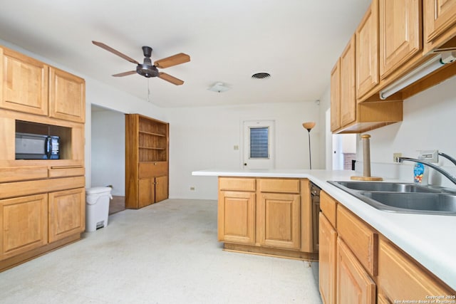 kitchen with light countertops, visible vents, a sink, a peninsula, and black appliances