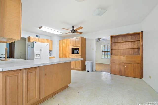 kitchen featuring light floors, a peninsula, a sink, light countertops, and white fridge with ice dispenser