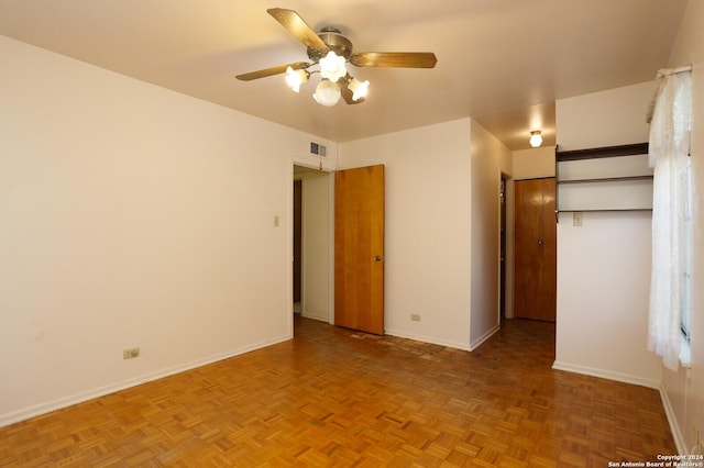 unfurnished bedroom featuring a ceiling fan, visible vents, and baseboards